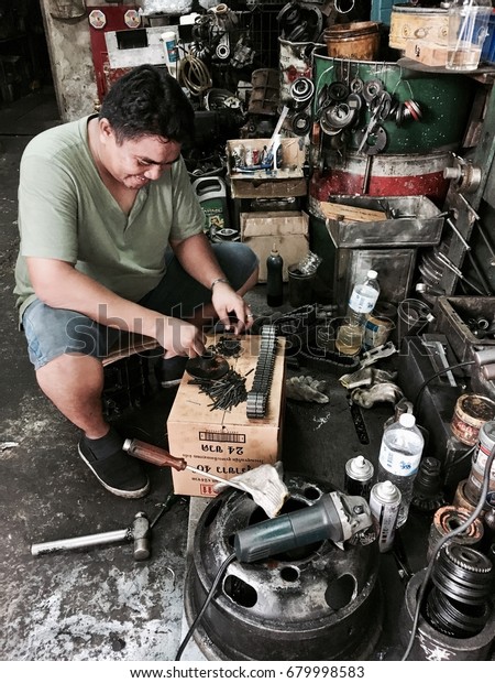 Bangkok Thailand - July 18,2017 : Spare parts shop\
( China Town ) in Bangkok , Thailand. Technicians are repairing\
parts.