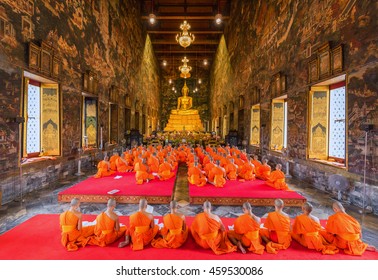 Bangkok, Thailand - July 20, 2016: Buddhist Monks praying and pay respect to the Buddha image at Wat Suthat on Buddhist Lent Day. he Buddhist Lent Day is The First Day of Rainy Season Retreat.