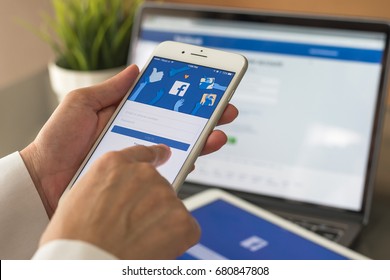 BANGKOK, THAILAND - July 20, 2017: Facebook social media app logo on log-in, sign-up registration page on mobile app screen on iPhone smart devices in business person's hand at work