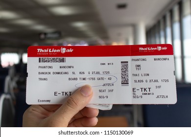 Bangkok, Thailand - July 27, 2018 : close-up hands hold boarding pass from Don Mueang International Airport,Bangkok provance to Trang provance Thailand of Thai Lion Airairlines.
