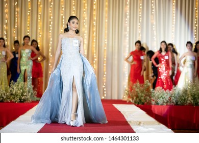Bangkok, Thailand - July 28, 2019 ; Miss Beauty Contest Pageant named "Miss & Mr Siam China 2019", Beautiful Woman Contestants in Blue Evening Gown Costume walk present on Stage at Amari Airport Hotel