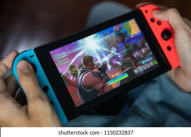 Bangkok, Thailand - July 30, 2018 : Gamer playing Fortnite game on Nintendo Switch.