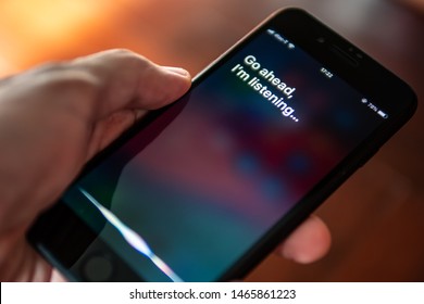 Bangkok, Thailand - July 30, 2019 : Siri, Apple's voice-activated digital assistant, tells iPhone user to ask her by showing the text "Go ahead, I'm listening" on the display.
