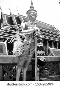Bangkok, Thailand - July 6, 2009:  Statue of a golden kinnara (half human, half horse) at the Grand Palace (black and white)