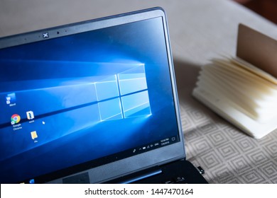 Bangkok, Thailand - July 9, 2019 : Laptop Computer Showing Its Screen With Microsoft Windows Logo On Desktop.