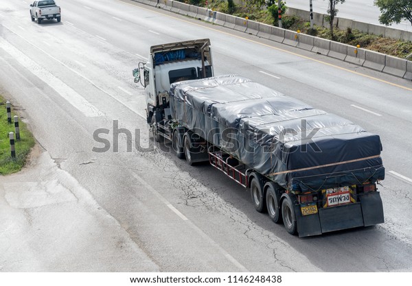 Bangkok,\
Thailand - July,22,2018: Truck covered canvas when running on the\
highway, on July,22,2018 in Bangkok,\
Thailand