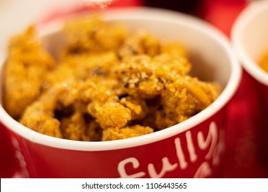 BANGKOK, THAILAND - JUNE 06, 2018: KFC, Kentucky Fried Chicken Food: Chicken Nuggets Bucket, takoyaki Sauce and pepsi cola water . KFC is a Worldwide Famous American Fast Food Restaurant. blurred
