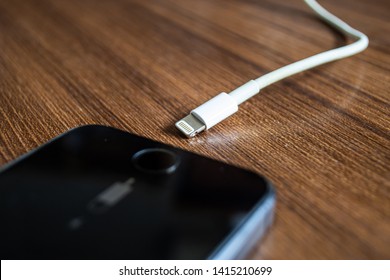 Bangkok, Thailand - June 1, 2019 : Lightning charger cable with Apple iPhone 5s.