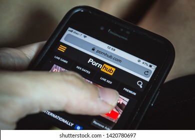 Bangkok, Thailand - June 10, 2019 : Internet user browsing Pornhub.com on smartphone.