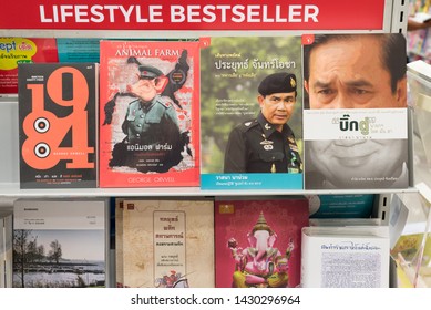 Bangkok, Thailand - June 13, 2019: Books About Thailand Prime Minister Prayut Chan-o-cha Next To George Orwell's Dystopias Animal Farm And 1984 On A Shelf Called Lifestyle Bestseller At A Bookstore