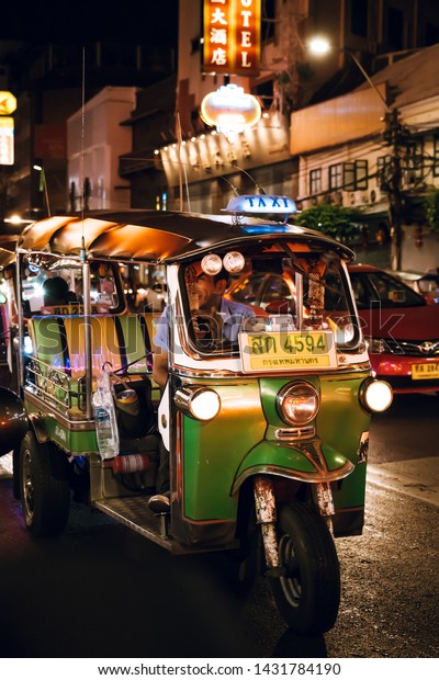 Bangkok, Thailand - June 16,2019 : Famous\
moto-taxi called tuk-tuk is a landmark of the city and popular\
transport, Tuk tuk on the street in Chinatown, street food night\
market in bangkok\
thailand.