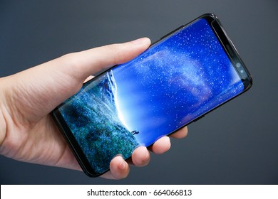 BANGKOK, THAILAND - JUNE 21: Samsung Galaxy S8 With Galaxy Wallpaper On Hand On June 21, 2016 In Bangkok, Thailand