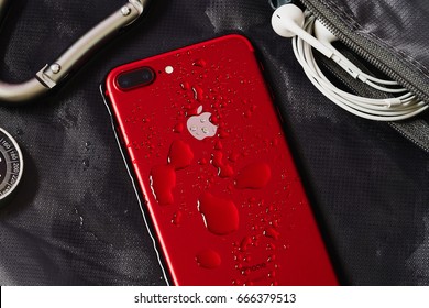 BANGKOK, THAILAND - June 25, 2017: Water drop on back side of iPhone 7 Plus Apple Product Red with new feature Splash, Water, and Dust Resistant Technology