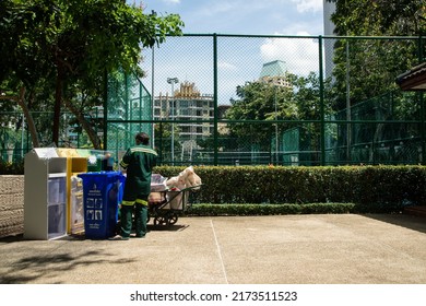 BANGKOK ,THAILAND - JUNE 6 , 2022 : Unidentified Female Worker Is Sorting Waste From Classified Waste Bins At Benchasiri Public Park. Which Is A Daily Work.