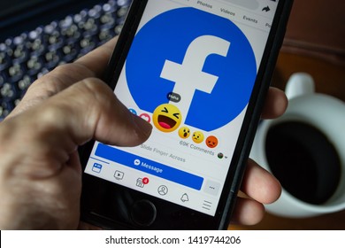Bangkok, Thailand - June 9, 2019 : Facebook user touch on Haha button in Facebook application on iPhone 7.