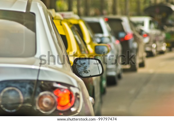 BANGKOK, THAILAND - A long queue of cars stuck\
in a traffic jam during peak rush\
hour