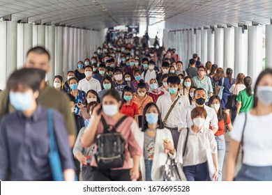 BANGKOK, THAILAND - MAR 2020 : Crowd of unrecognizable business people wearing surgical mask for prevent coronavirus Outbreak in rush hour working day on March 18, 2020 at Bangkok transportation