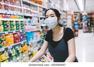 Bangkok, Thailand - Mar 22, 2018: Asian Woman Running Errands In Supermarket With Mask On Her Face