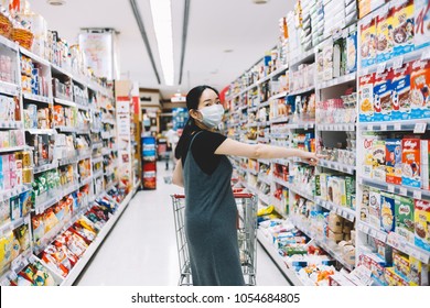 Bangkok, Thailand - Mar 22, 2018: Asian Woman Running Errands In Supermarket With Mask On Her Face