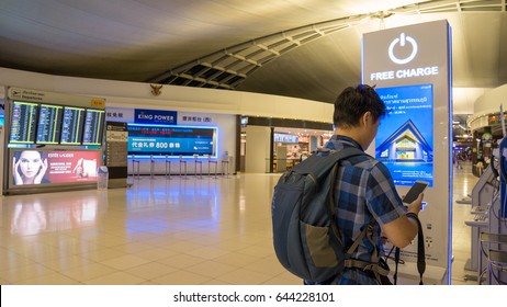 BANGKOK, THAILAND - MAR 23, 2017: Thai Traveler Charging Mobile Phone Battery At The Free Service Charging Station Area At Suvarnabhumi International Airport In Bangkok, Thailand.