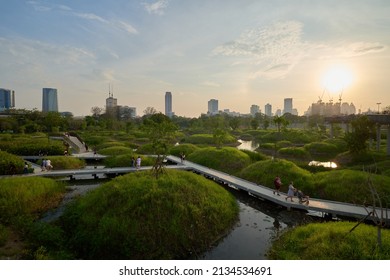 BANGKOK, THAILAND - MAR 6, 2022 : View of Benjakitti Forest Park, is new landmark public park of central Bangkok includes sky bridge, walking path and central lake. Many people are visiting this place