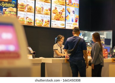 BANGKOK, THAILAND - MARCH 02: Unnamed Mcdonald's employee takes food order from customers in Victoria's Garden on Petchkasem in Bangkok on March 02, 2020.