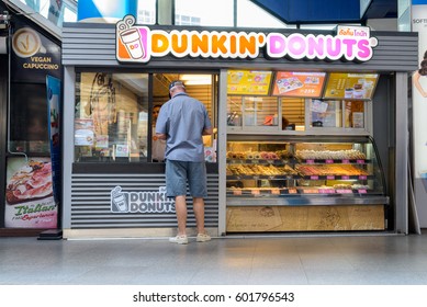 BANGKOK, THAILAND MARCH 1, 2017: Dunkin' Donuts Store Outside Sukhumvit Road Where Customer Is Ordering Donuts. Dunkin' Donuts Is An American Global Doughnut Franchise Company And Coffee House Chain.