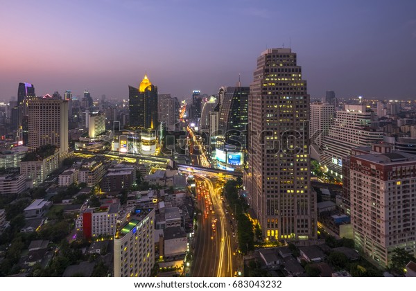 BANGKOK,\
THAILAND - March 11, 2014 : Asok Intersection. It was the Traffic\
density. This place is very famous shopping mall with car light\
trails and twilight effect Bangkok,\
Thailand.
