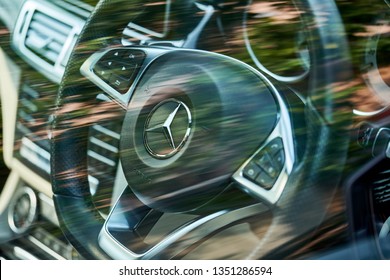 BANGKOK, THAILAND - MARCH 18, 2019: Mercedes Benz Logo On Steering View With Selective Focus & Reflection Of Green Leaves On Glass Window Tint. Illustration Of Environment Friendly & Hybrid Vehicle