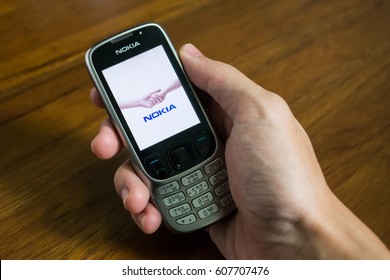 Bangkok, Thailand - March 24, 2017 : Nokia mobile phone held in one hand showing its screen with Nokia logo.
