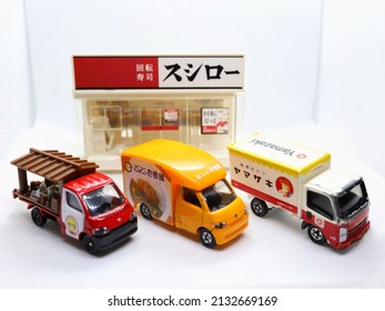 Bangkok, Thailand - March 3, 2022: Model of three food trucks (ramen, curry rice and bread trucks) in front of sushi restaurant called Sushiro.