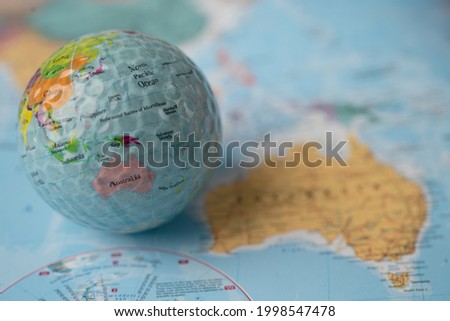 Bangkok, Thailand, May 1, 2021 Australia map at golf ball with flag on world globe map.