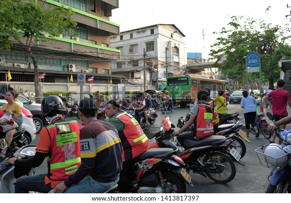 Bangkok, Thailand - May 14 2019: One of the\
fastest ways to travel around the city is to ride a Bangkok\
motorcycle taxi. Motorbike taxi drivers are waiting for passengers\
in Hwai Khwang market.