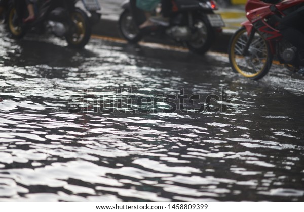 Bangkok ,Thailand ,May 16 ,2019-Flood on\
public road and motorcycles in traffic\
jam