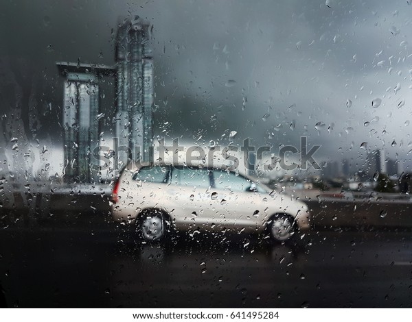 Bangkok, Thailand - May 17, 2017 : A car on the road,\
heavy raining day all around the city, it makes trouble with a\
traffic jam