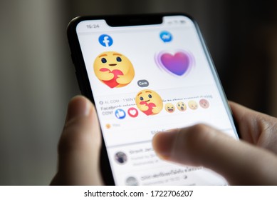 Bangkok, Thailand - May 2, 2020 : Facebook User Touch On Care Emoji Button In Facebook Application On IPhone 11.