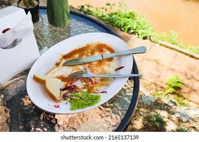 Bangkok, Thailand - May 2, 2022 : The Leftover Food And Dirty Dishes On The Restaurant Table.