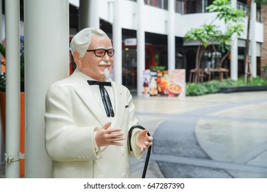 BANGKOK ,THAILAND- May 20 ,2017: Colonel Harland Sanders statue standing in front of Kentacky Fried chicken restaurant (KFC)