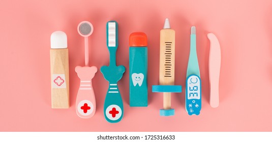 Bangkok, Thailand : May, 2020. Wooden Toy Set Flat Laying On The Pink Background In The Concept Of Dental Caries, Gum Disease, Dental Implant  And Having Good Dental Health.