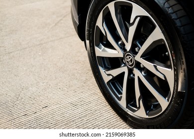 Bangkok, Thailand - MAY 22, 2022 : Close up of alloy wheel tyre of All-new Toyota Corolla Cross car with 1.8 litre hybrid engine. Famous world brand. Modern transportation.