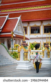 BANGKOK, THAILAND – MAY 26: People Walk In Candlelight Inside The Temple, A Traditional Thai Tradition Passed Down On Important Buddhist Days On May 26, 2021 In Bangkok, Thailand.