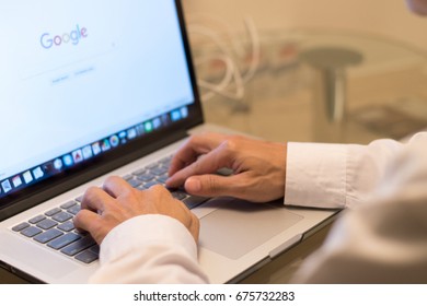 BANGKOK, THAILAND - May 27, 2017: Business Man Using Macbook With Google Search Engine On Web Page   Working At Night 