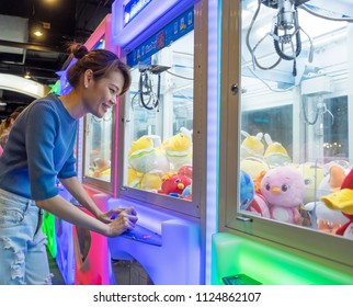 BANGKOK, THAILAND - May 29: Union Mall Shopping Center on May 29,2018 in Bangkok, Thailand. Happiness Woman Playing Claw Game or Cabinet to Catch the Dolls