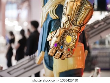 Bangkok, Thailand - May 4, 2019 :  A Closed Up Photo Of Thanos's Infinity Gauntlet, Gold Glove With Luminous Stones. Thanos Is A Super Villain From Avengers Movie, Production By Marvel Studio.