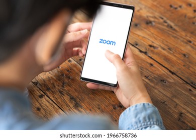 Bangkok Thailand - May 4, 2021: Close Up Of A Working Woman's Hand Turning On Zoom Application To Start Video Meeting With Her Colleague While She'e Remote Working During Covid 19 Pandemic. 