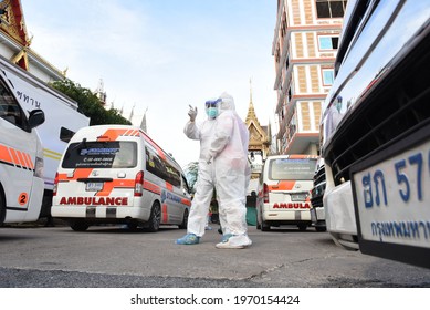 Bangkok, Thailand - May 8, 2021 Ambulance With Volunteers Dressed In PPE Clothes Ready To Bring Covid-19 Infected People From Wat Saphan Klong Toey To Hospital. To Heal In The Public Health System.