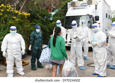 Bangkok, Thailand - May 8, 2021 Ambulance With Volunteers Dressed In PPE Clothes Ready To Bring Covid-19 Infected People From Wat Saphan Klong Toey To Hospital. To Heal In The Public Health System.