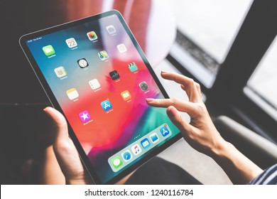 Bangkok, Thailand - Nov 22, 2018: Asian Woman Using The New 11 Inch Apple IPad Pro 2018, Swiping Home Screen Or Touching App Icon. Illustrative Editorial Content