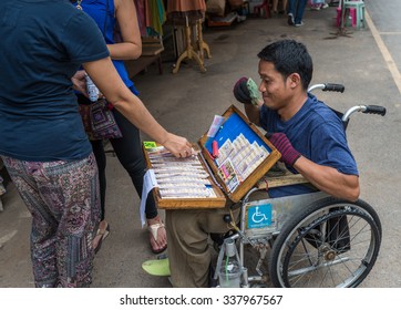 Bangkok, Thailand - Nov 7, 2015 Unidentified Man On Wheel Chair Is Selling Lotterry At Chatuchak, The Biggest Weekend Market In South East Asia.