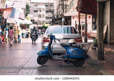 Bangkok, Thailand - November 11, 2018: A Blue Vintage Vespa Delivery Scooter Sits Parked Up At A Market China Town Under Shade